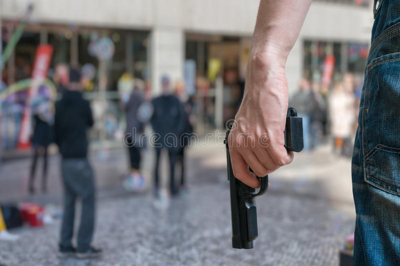 a man wearing jeans and holding a gun